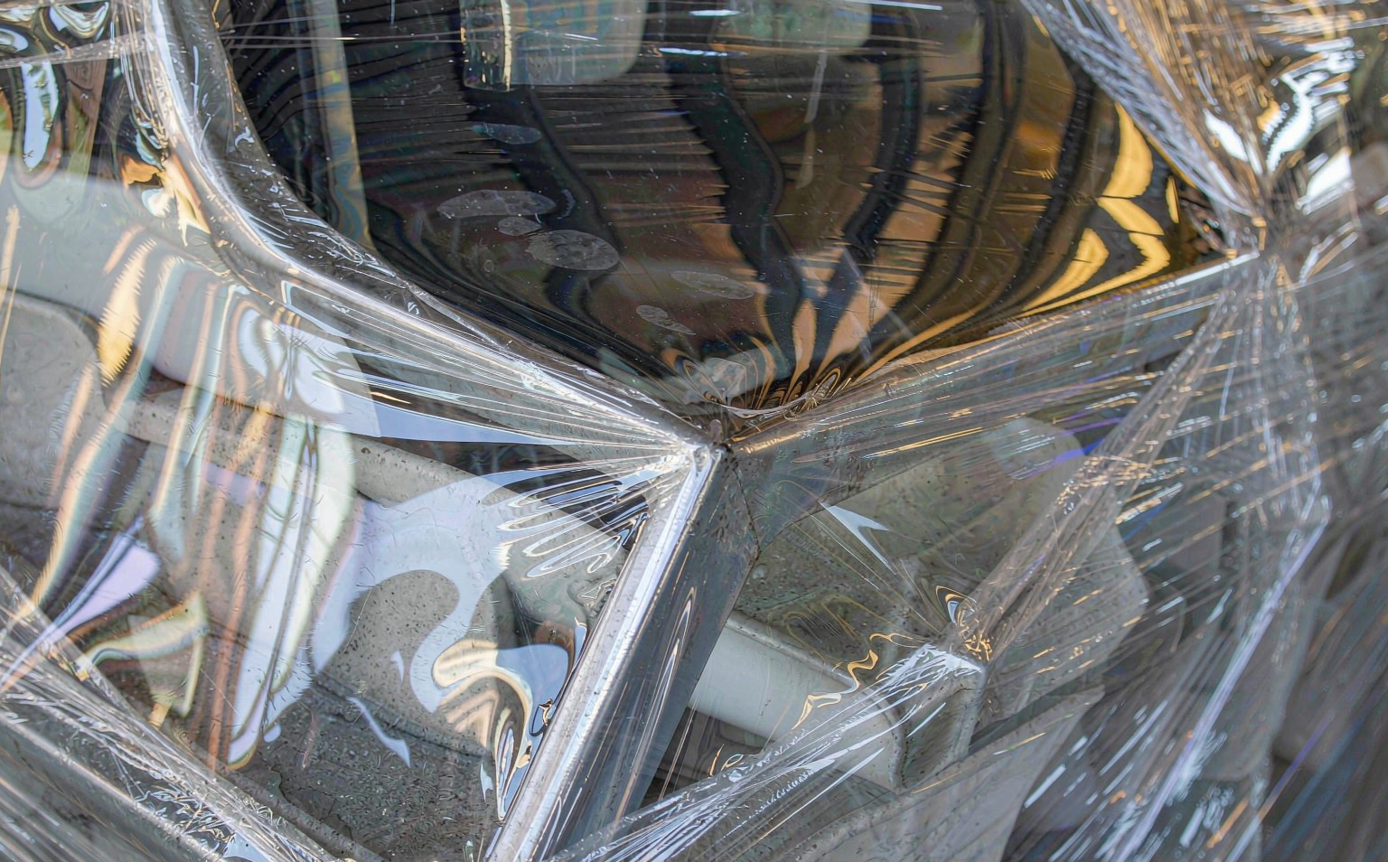Close-up of puncture-resistant stretch film stretched over sharp-edged metal parts on a pallet corner