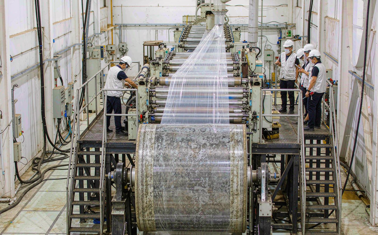 Factory floor view of a multi-layer co-extrusion stretch film production line producing puncture-resistant grade